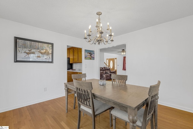 dining room with light hardwood / wood-style flooring and a textured ceiling