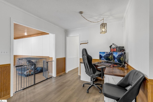 office area with crown molding, a multi sided fireplace, a textured ceiling, and light hardwood / wood-style flooring