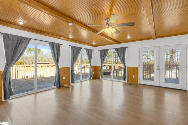 interior space with beamed ceiling, wood ceiling, french doors, and a wealth of natural light