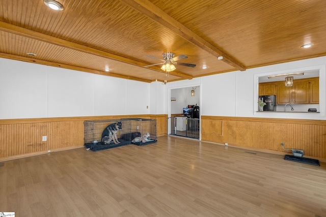 misc room with wood ceiling, ceiling fan, beam ceiling, and light hardwood / wood-style floors