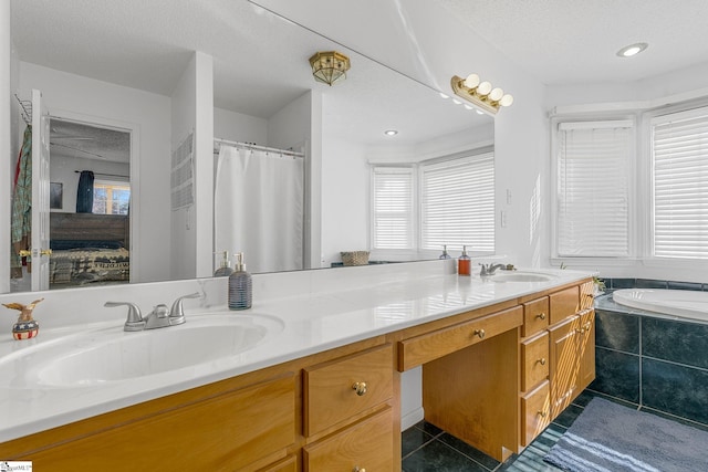 bathroom with tile patterned flooring, vanity, a wealth of natural light, and a textured ceiling