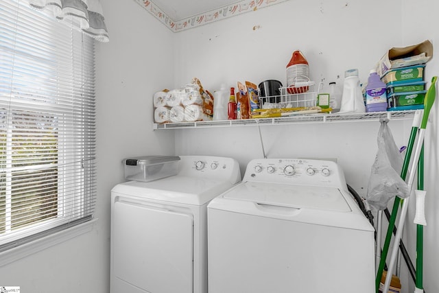 clothes washing area with a healthy amount of sunlight and washer and clothes dryer