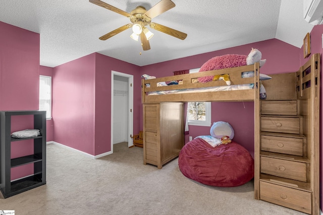 bedroom featuring ceiling fan, light colored carpet, and a textured ceiling