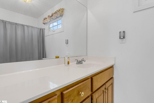 bathroom with vanity and a textured ceiling