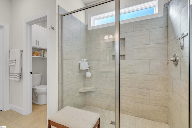 bathroom with a shower with shower door and toilet