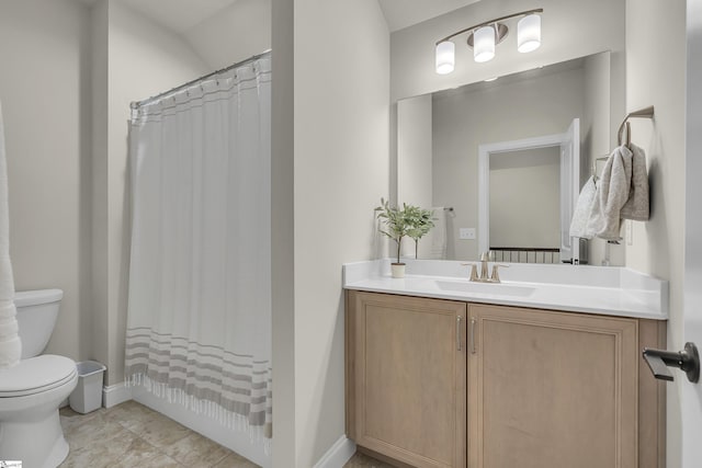 bathroom with vanity, toilet, and tile patterned flooring