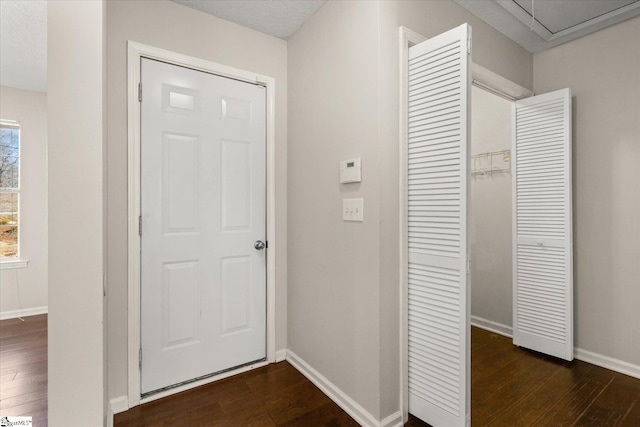 corridor with dark hardwood / wood-style flooring