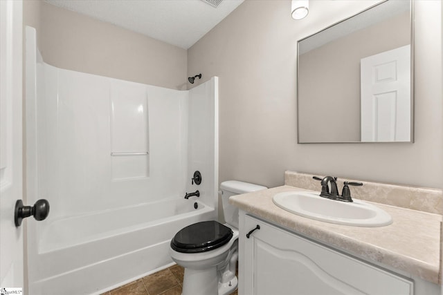 full bathroom featuring tile patterned flooring, vanity,  shower combination, toilet, and a textured ceiling