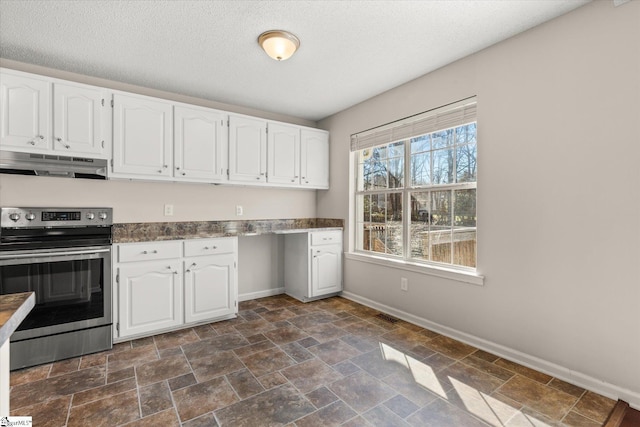 kitchen featuring white cabinetry, stainless steel electric stove, built in desk, and a textured ceiling