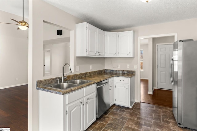 kitchen featuring sink, white cabinetry, a textured ceiling, appliances with stainless steel finishes, and ceiling fan