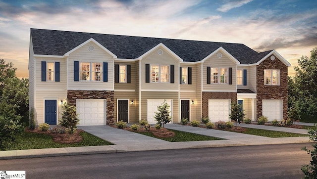 view of front of house featuring a garage, stone siding, and driveway