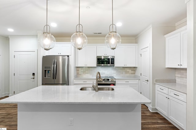 kitchen featuring pendant lighting, white cabinetry, appliances with stainless steel finishes, and an island with sink