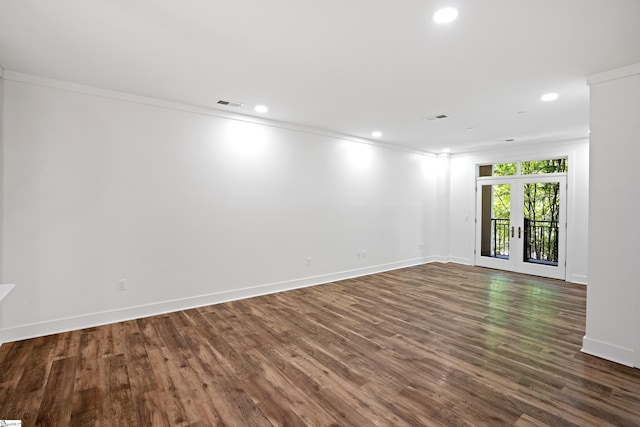 unfurnished room with dark hardwood / wood-style flooring, crown molding, and french doors