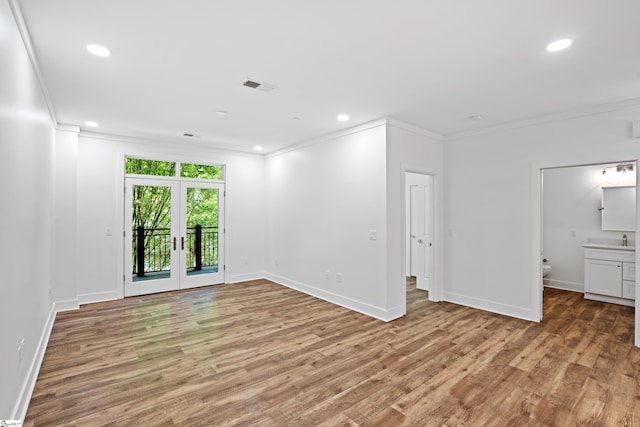 unfurnished room with french doors, crown molding, sink, and light hardwood / wood-style flooring