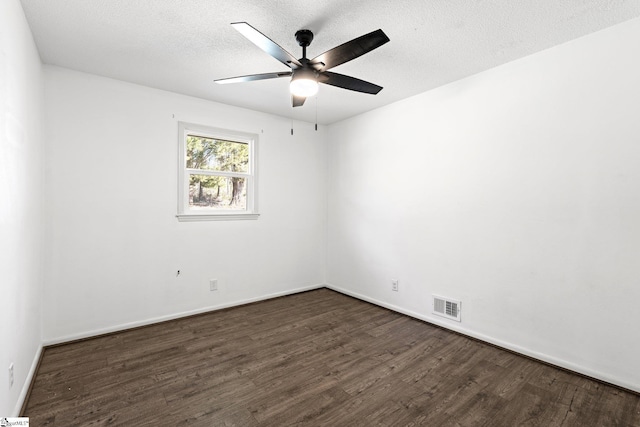 unfurnished room with ceiling fan, dark hardwood / wood-style floors, and a textured ceiling