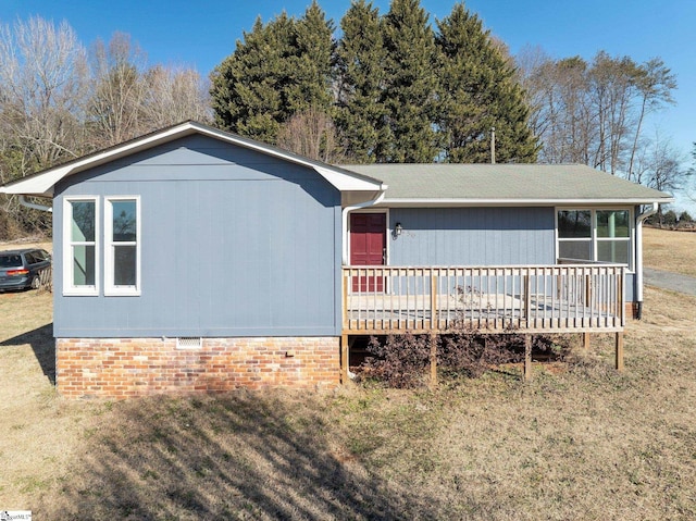 view of front of house with a front yard and a deck