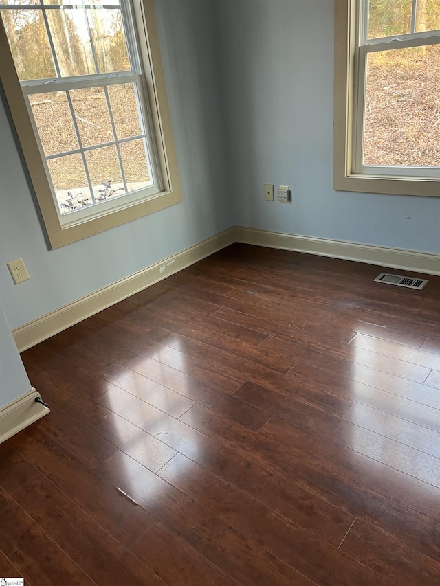 spare room with dark hardwood / wood-style floors