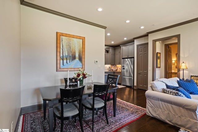 dining space featuring crown molding and dark hardwood / wood-style floors