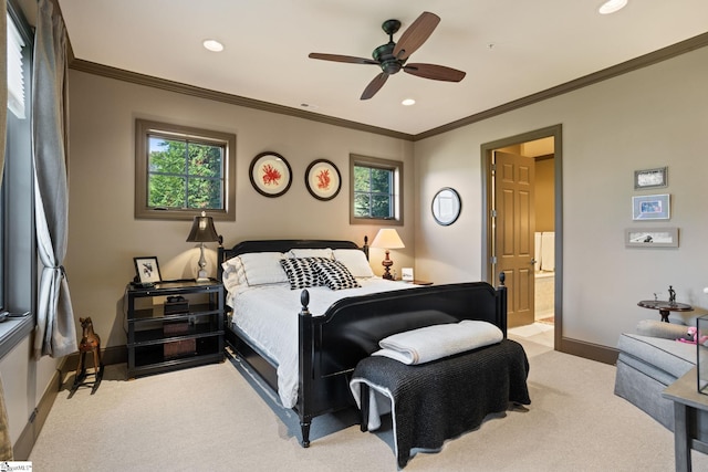 carpeted bedroom with ornamental molding, connected bathroom, and ceiling fan