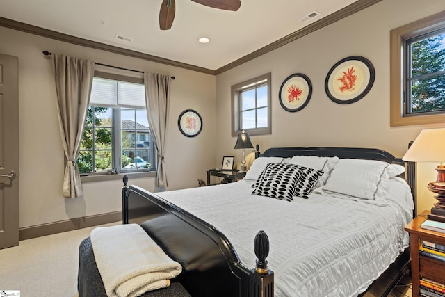 carpeted bedroom with crown molding and ceiling fan