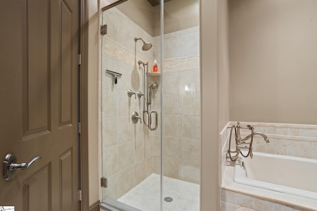 bathroom featuring shower with separate bathtub