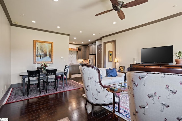 living room featuring crown molding, dark hardwood / wood-style floors, and ceiling fan