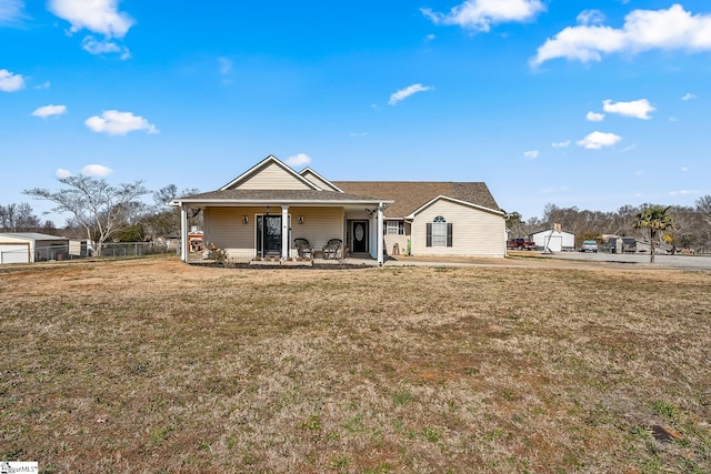 view of front of home with covered porch and a front lawn