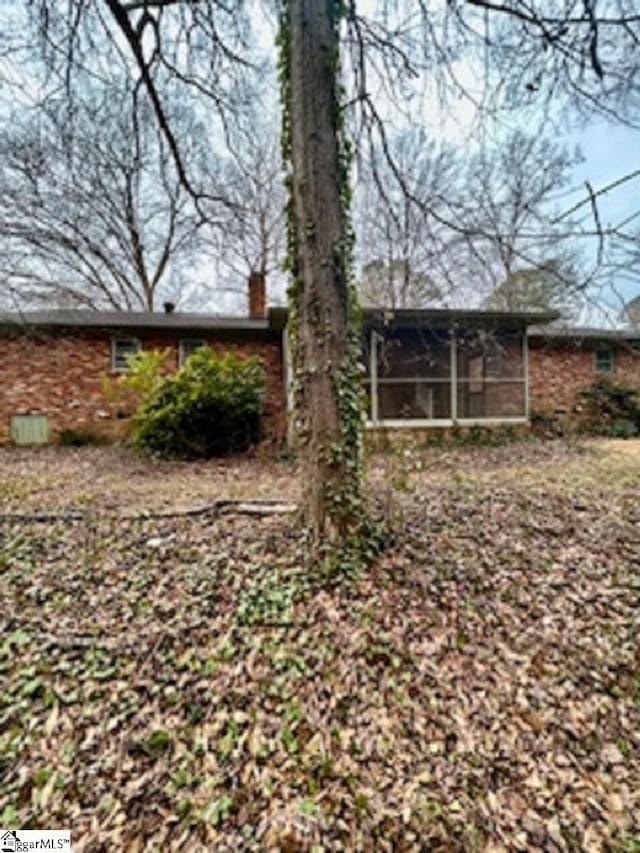 back of house featuring a sunroom