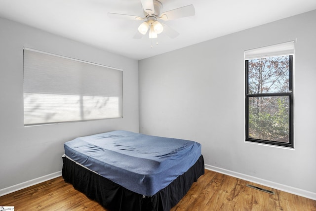 bedroom featuring hardwood / wood-style flooring and ceiling fan