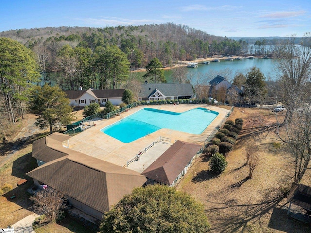 view of swimming pool with a patio and a water view