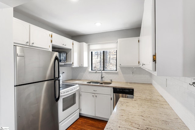 kitchen featuring stainless steel appliances, light stone countertops, sink, and white cabinets