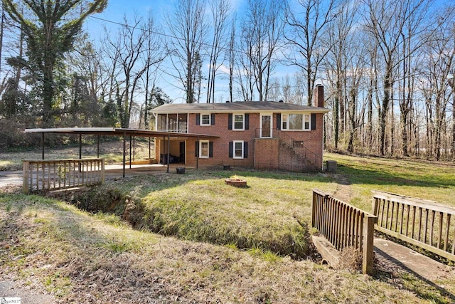 view of front facade featuring a wooden deck and a front yard