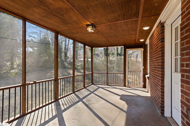 unfurnished sunroom featuring wood ceiling