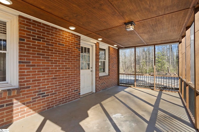 unfurnished sunroom featuring wooden ceiling