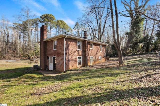 view of home's exterior featuring a yard and central air condition unit