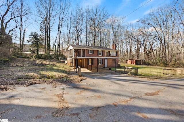 view of front of home featuring a carport and a sunroom