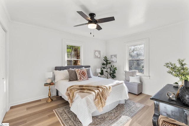 bedroom with crown molding, ceiling fan, and light wood-type flooring