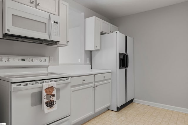 kitchen with white appliances and white cabinets