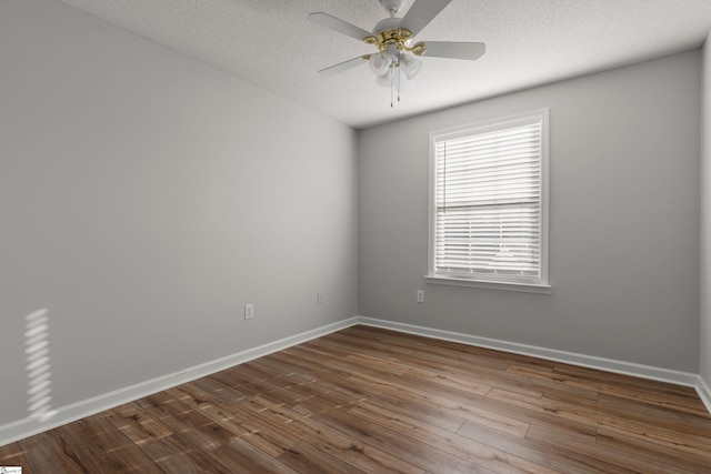 empty room featuring wood-type flooring, ceiling fan, and a textured ceiling