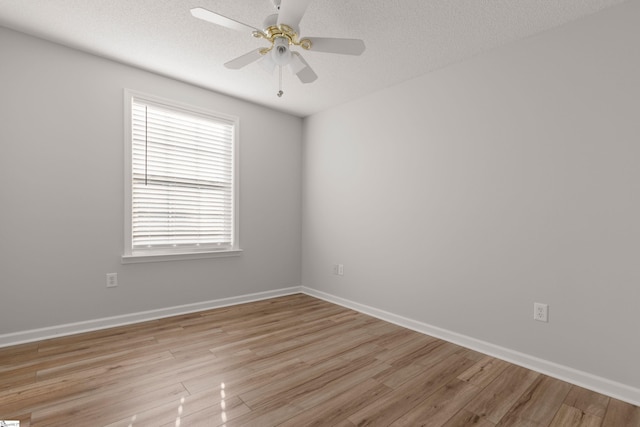 unfurnished room featuring ceiling fan, light hardwood / wood-style flooring, and a textured ceiling