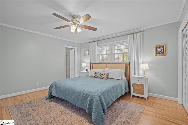 bedroom with ornamental molding, ceiling fan, and light hardwood / wood-style floors