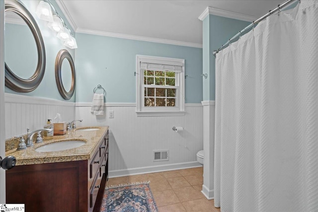 bathroom with tile patterned flooring, vanity, ornamental molding, and toilet