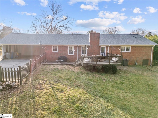 back of house featuring cooling unit, a wooden deck, a yard, and a patio area