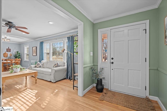 foyer featuring light hardwood / wood-style flooring, ornamental molding, and ceiling fan