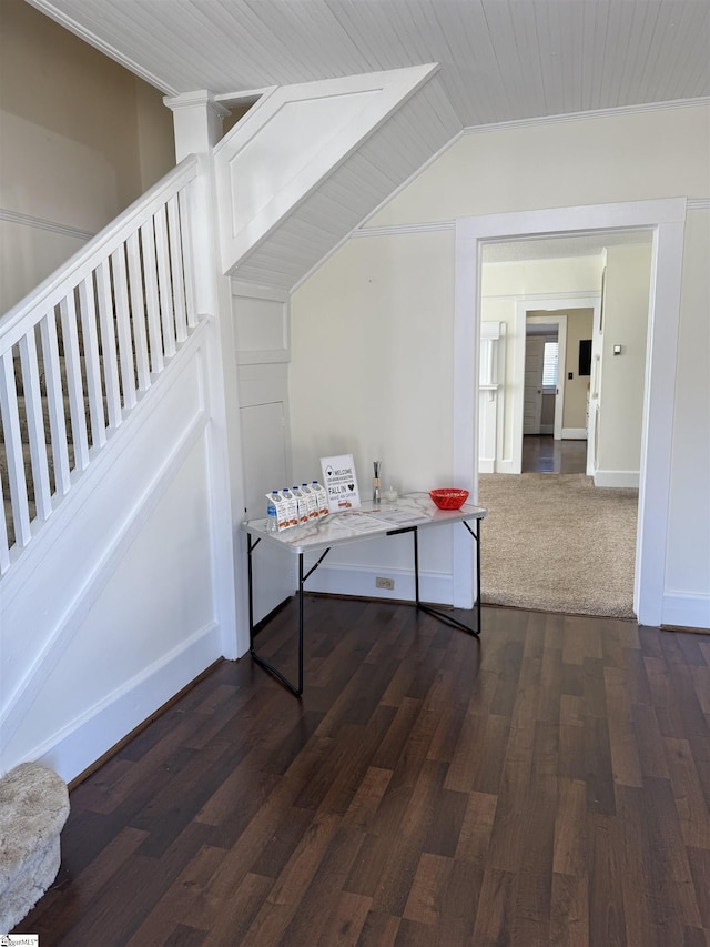 interior space with dark wood-type flooring and vaulted ceiling