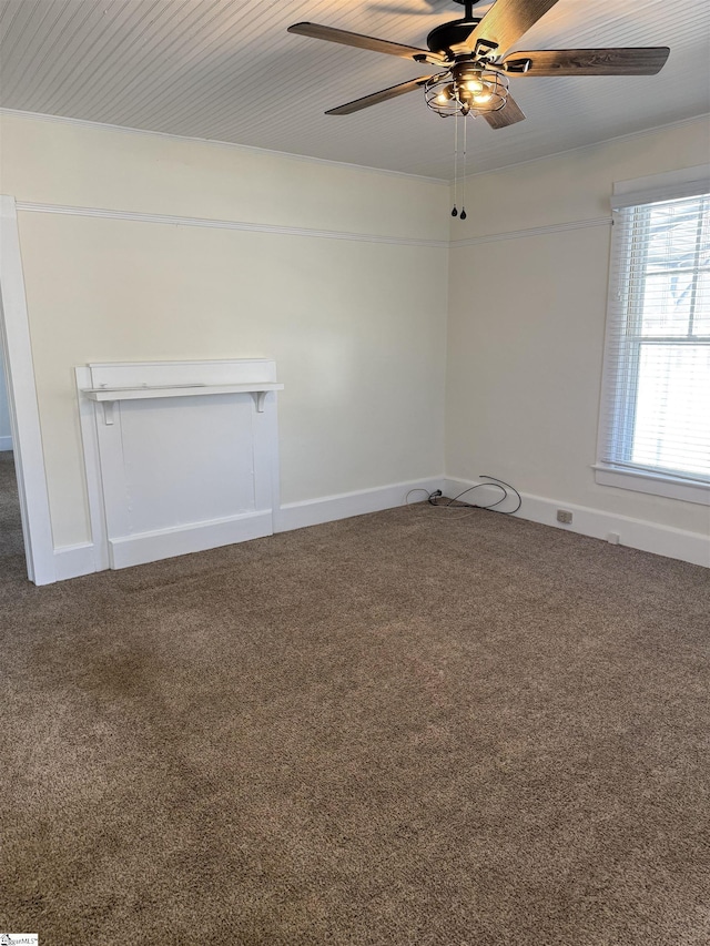 spare room featuring dark colored carpet and ceiling fan