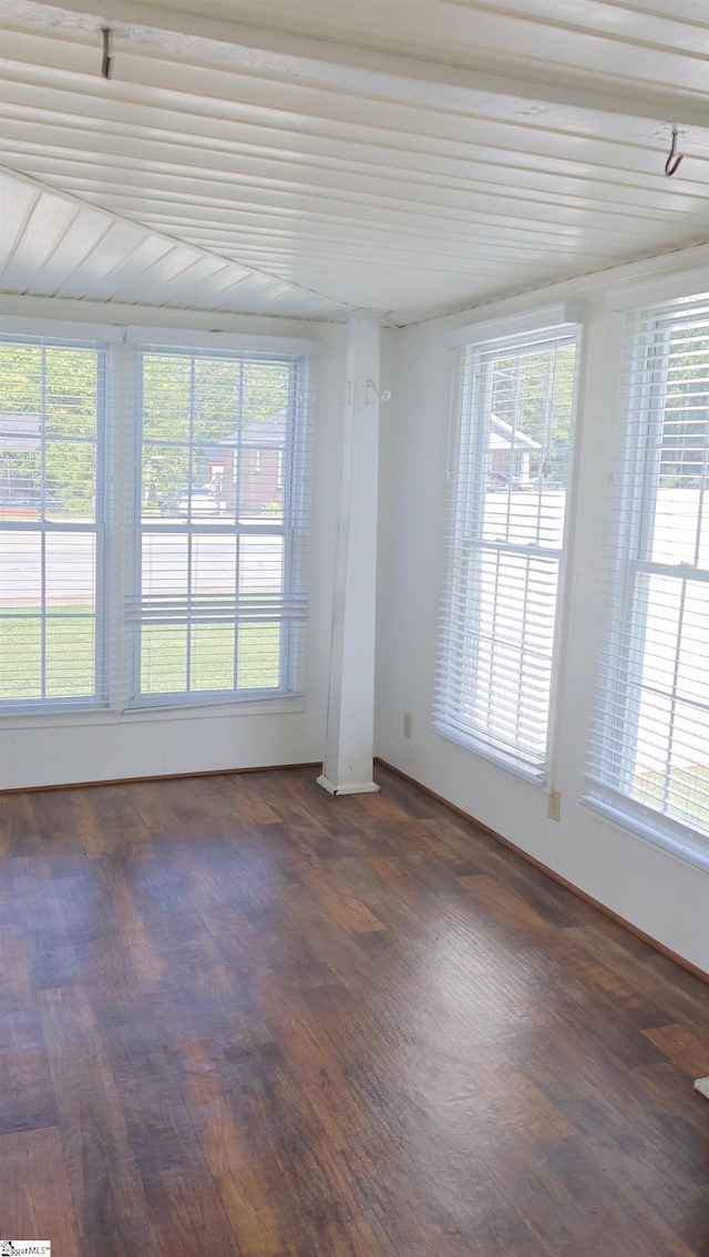 unfurnished room with dark wood-type flooring