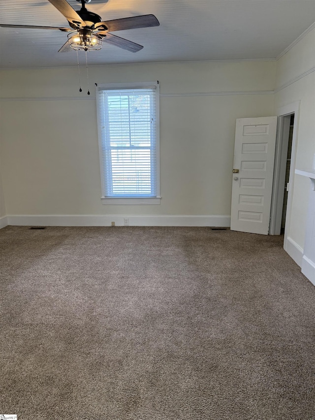 spare room with ceiling fan and carpet