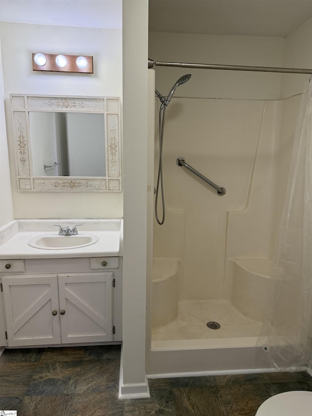 bathroom with a shower and vanity