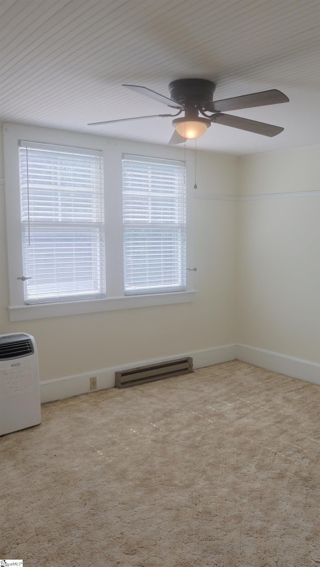 carpeted spare room with baseboard heating